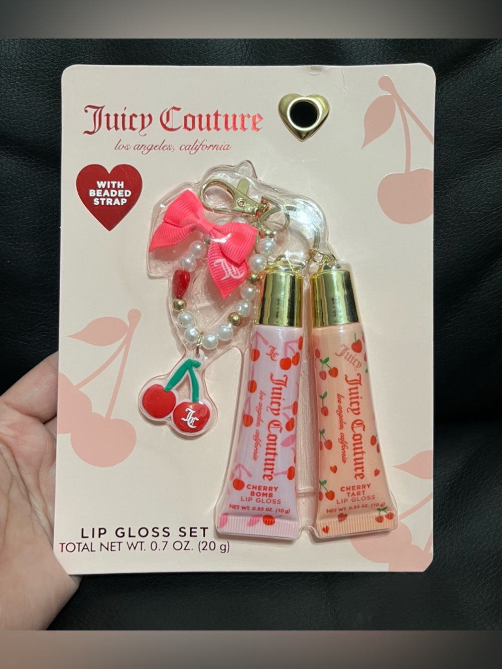 Juicy Couture lip gloss set that includes a beaded cherry keychain